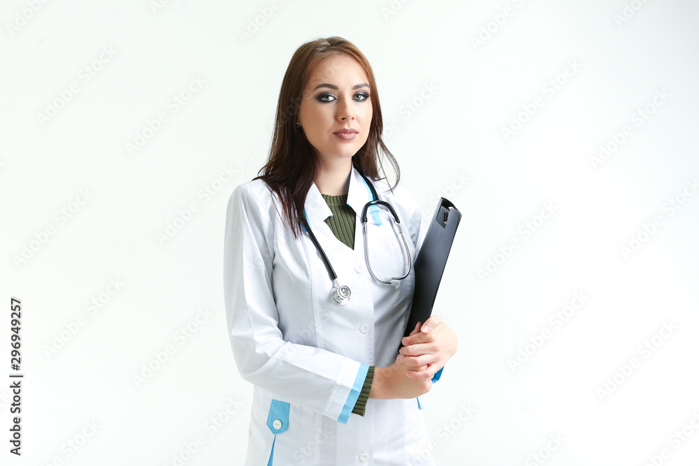 young female doctor with a folder in her hands on a white background young female doctor with a folder in her hands on a white background