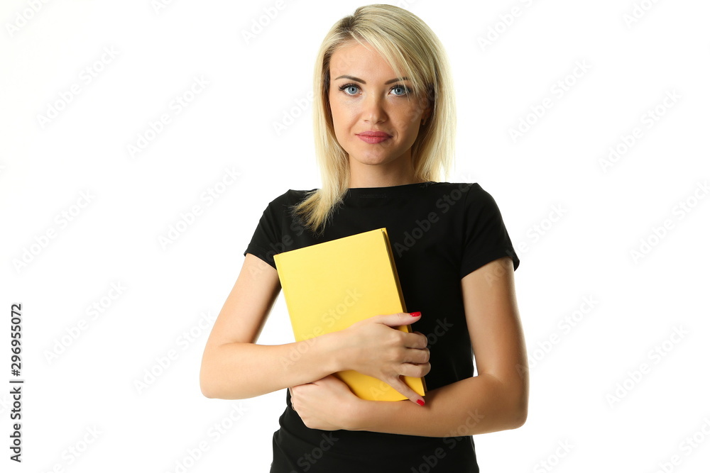 beautiful blonde in a black T-shirt holds a yellow book with two hands on white background with copy space beautiful blonde in a black T-shirt holds a yellow book with two hands on white background with copy space