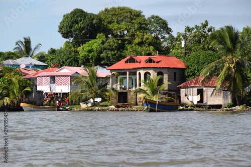 Beautiful houses on the shore of the great lake with boats, green trees and large surrounding houses.