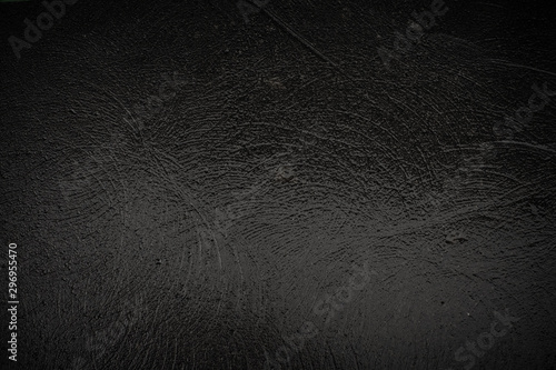 Texture of black granite wet stone with traces of grinding photo