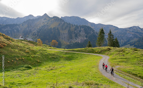 three happy senior adults, riding their mountain bikes in the autumnal atmosphere of the Bregenz Wald mountains near Mellau, Vorarlberg, Austria photo