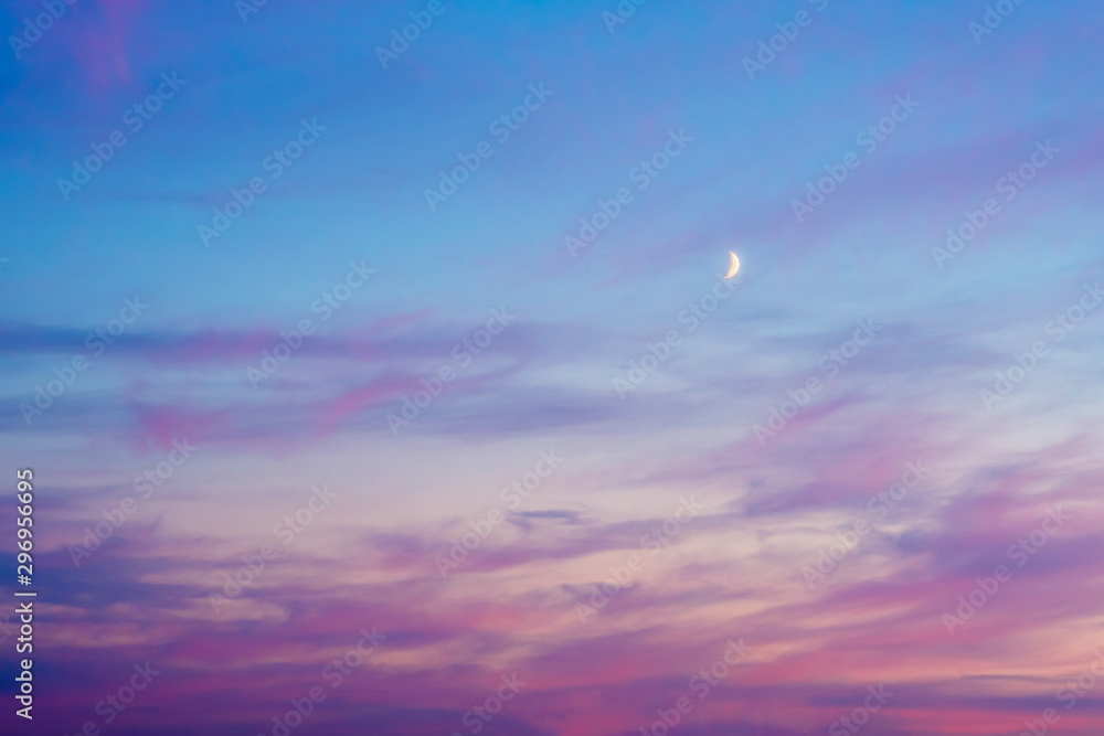 Red sunset sky with crescent moon..