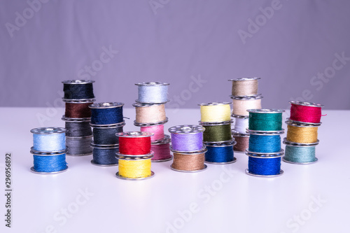 Colorful thread reels on a white background