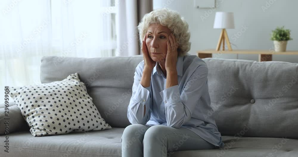Stressed worried older woman concerned about health problems at home Stressed worried older woman concerned about health problems at home
