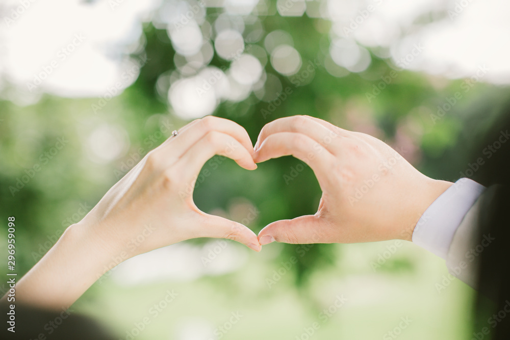 Young man and girl Couple in love gesturing heart with finger,valentine day concept. Young man and girl Couple in love gesturing heart with finger,valentine day concept.