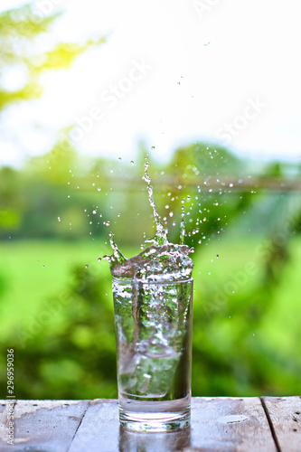 Water splashes in a glass of water on the table