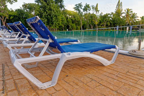 Beach chairs near swimming pool © adfoto