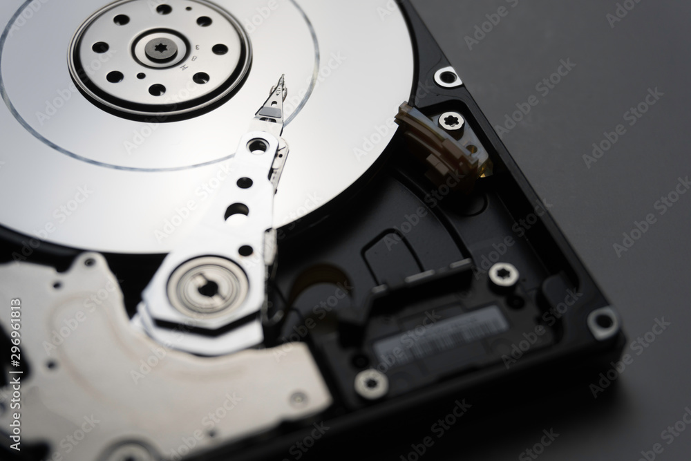Close up of hard disk's internal mechanism hardware. Soft focus at middle and background. Close up of hard disk's internal mechanism hardware. Soft focus at middle and background.