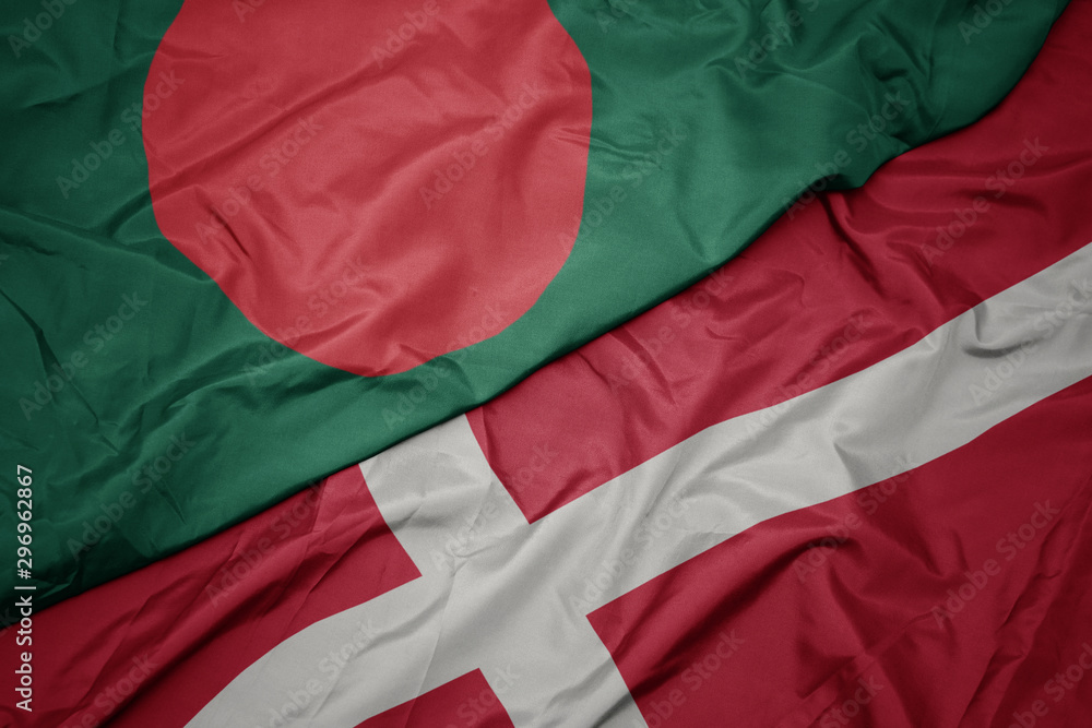waving colorful flag of denmark and national flag of bangladesh.