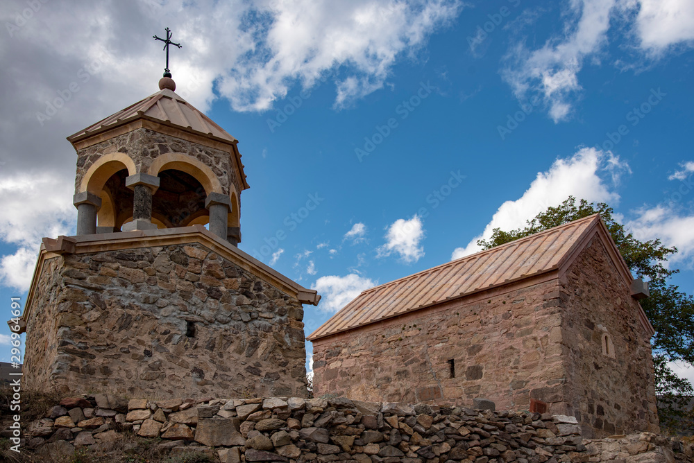 Armenian Church with bell tower on the background of blue cloudy sky.