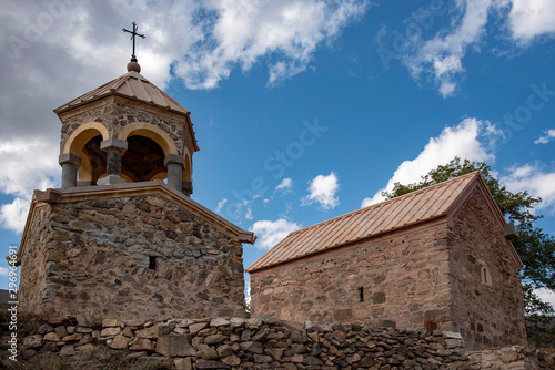 Armenian Church with bell tower on the background of blue cloudy sky.