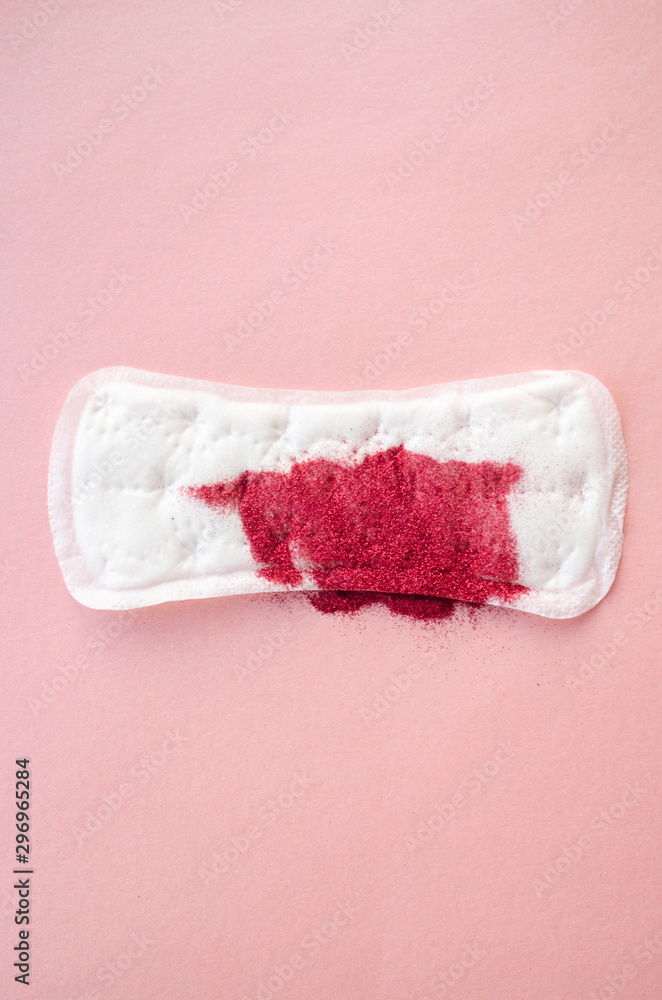 sanitary pad with red sparkles on a pink background. Menstruation concept sanitary pad with red sparkles on a pink background. Menstruation concept