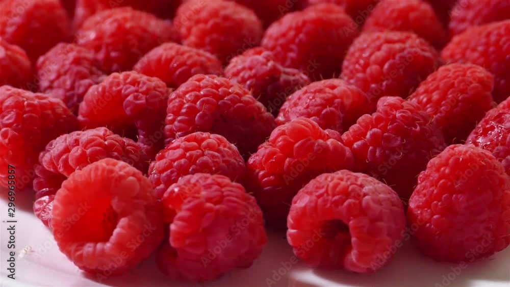 Raspberries turning background side view Raspberries turning background side view