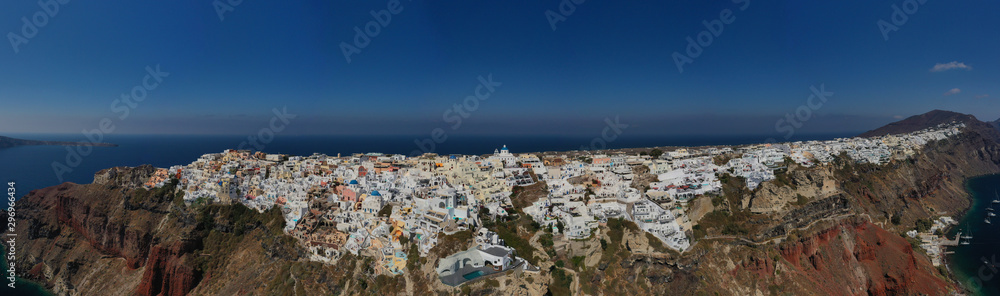 Aerial panoramic photo of iconic village of Oia built on a cliff in famous island of Santorini, Cyclades, Greece
