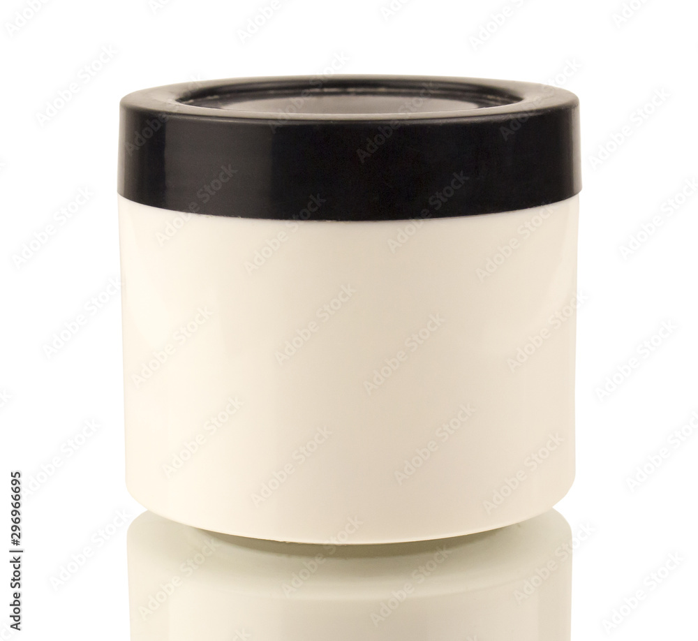 A round can of white color and a black lid for cosmetic products on a mirror surface A round can of white color and a black lid for cosmetic products on a mirror surface
