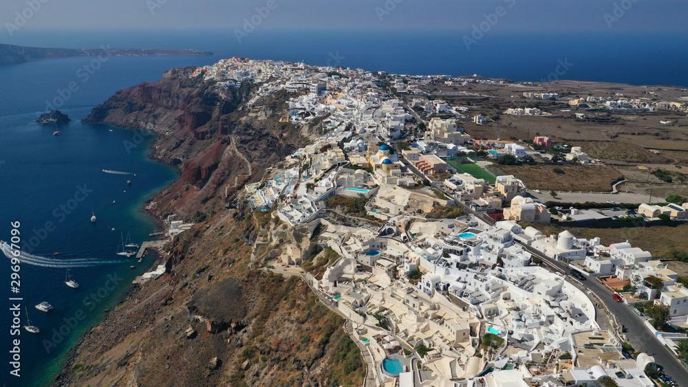 Aerial drone photo of traditional and picturesque village of Oia in volcanic island of Santorini, Cyclades, Greece