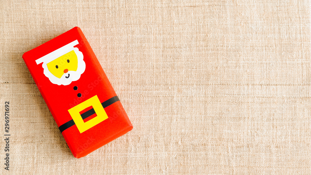 Obraz premium Christmas background with copy space. Top view of DIY santa gift boxes . Celebration of winter holidays concept