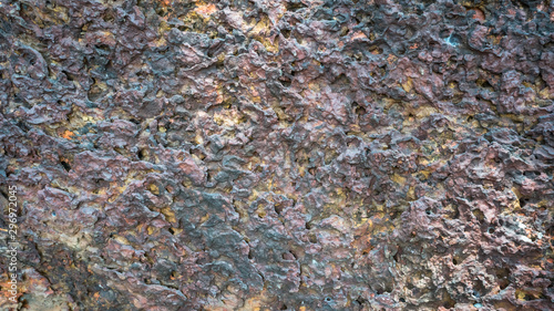 The porous texture of volcanic mineral. The geological structure of the stone. Abstract background in red brown colors. Space for text.