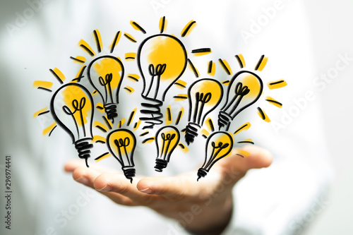  holding illuminated light bulb, idea, innovation and inspiration concept.