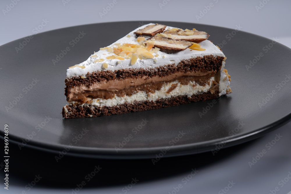 delicious cake with chocolate cream on a black plate2 delicious cake with chocolate cream on a black plate2