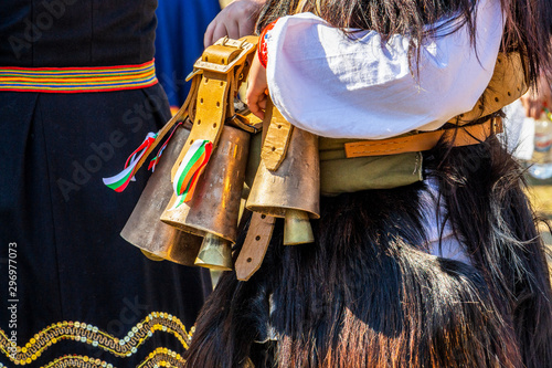 The specific Bulgarian bells, chanove, hang on the waist of a female participant at the National Festival Dervishi Varvara 2019, village of Varvara, Pazardzhik Province, Bulgaria photo