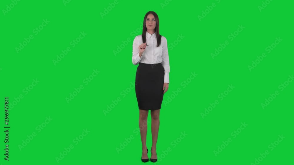 Young business woman using interactive virtual reality touch screen. Front view. Full body isolated on green screen chroma key background Young business woman using interactive virtual reality touch screen. Front view. Full body isolated on green screen chroma key background