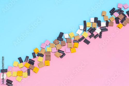 Liquorice Candy on a pink and turquoise background flat lay