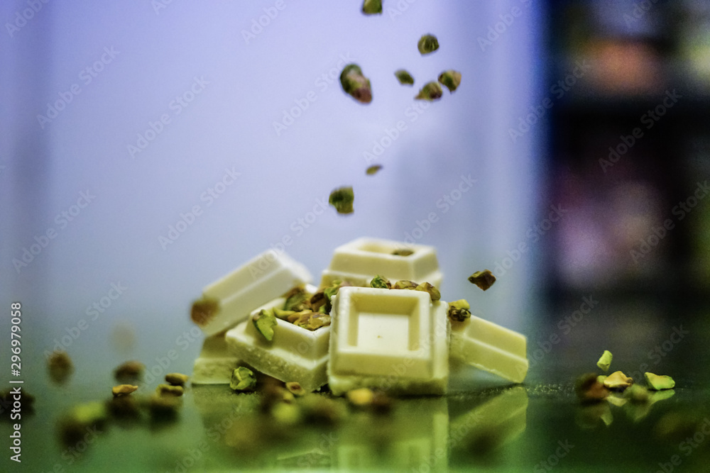 Green pistachios rain over white chocolate Green pistachios rain over white chocolate