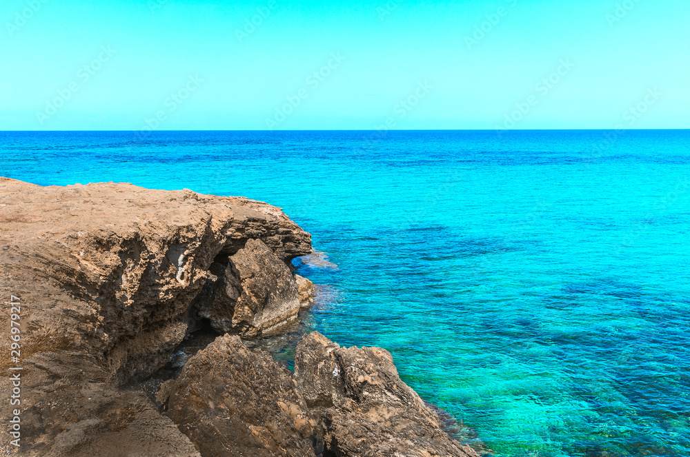 Beautiful seascape with a rocky beach and clear blue calm sea water. Northern Cyprus nature background Beautiful seascape with a rocky beach and clear blue calm sea water. Northern Cyprus nature background