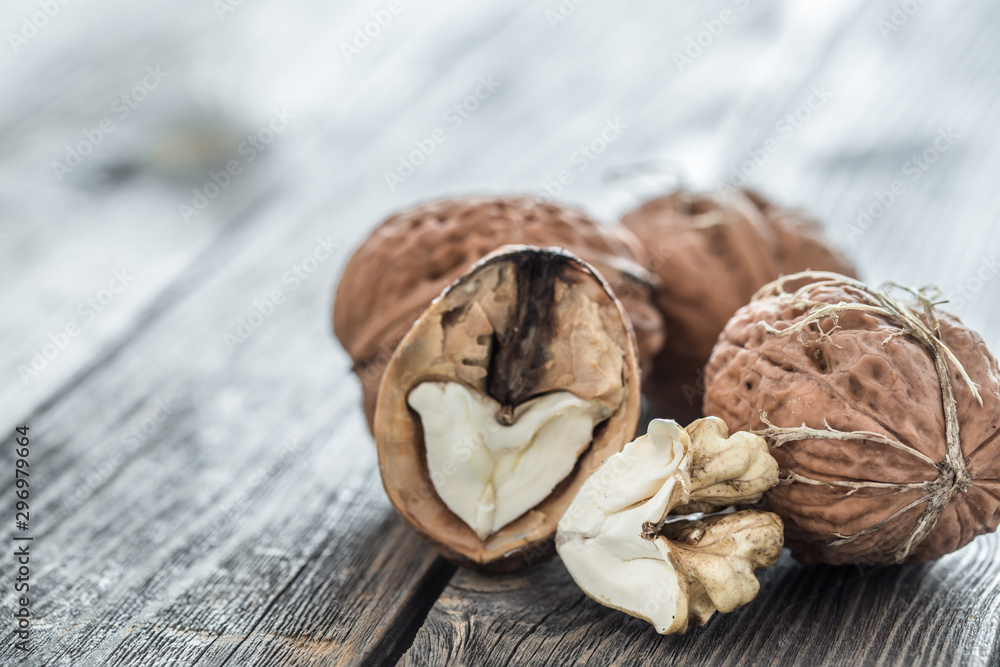 Walnut in open form on a wooden background, close-up . Walnut in open form on a wooden background, close-up .