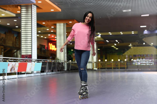 Young woman spending time at roller skating rink