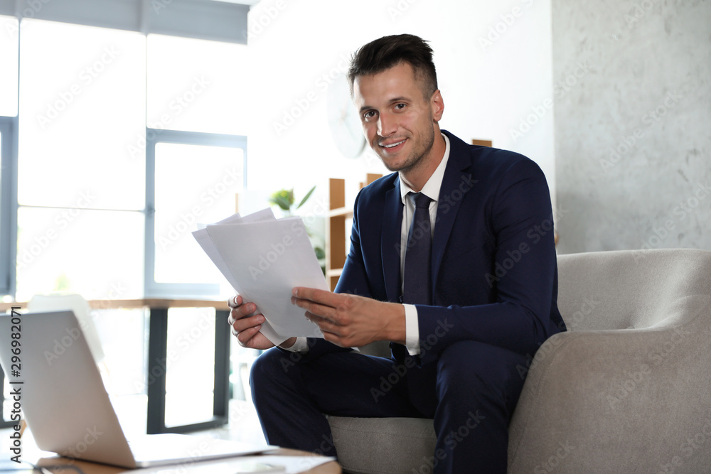 Male business trainer working with documents in office Male business trainer working with documents in office