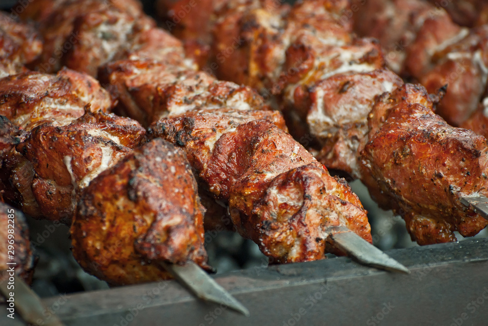 Barbecue fries in the coals. Meat and beef at the field kitchen festival.