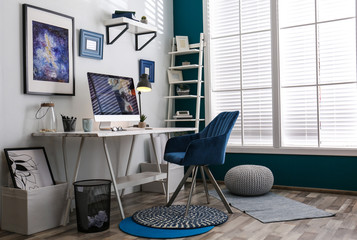 Home workplace with modern computer and desk in room