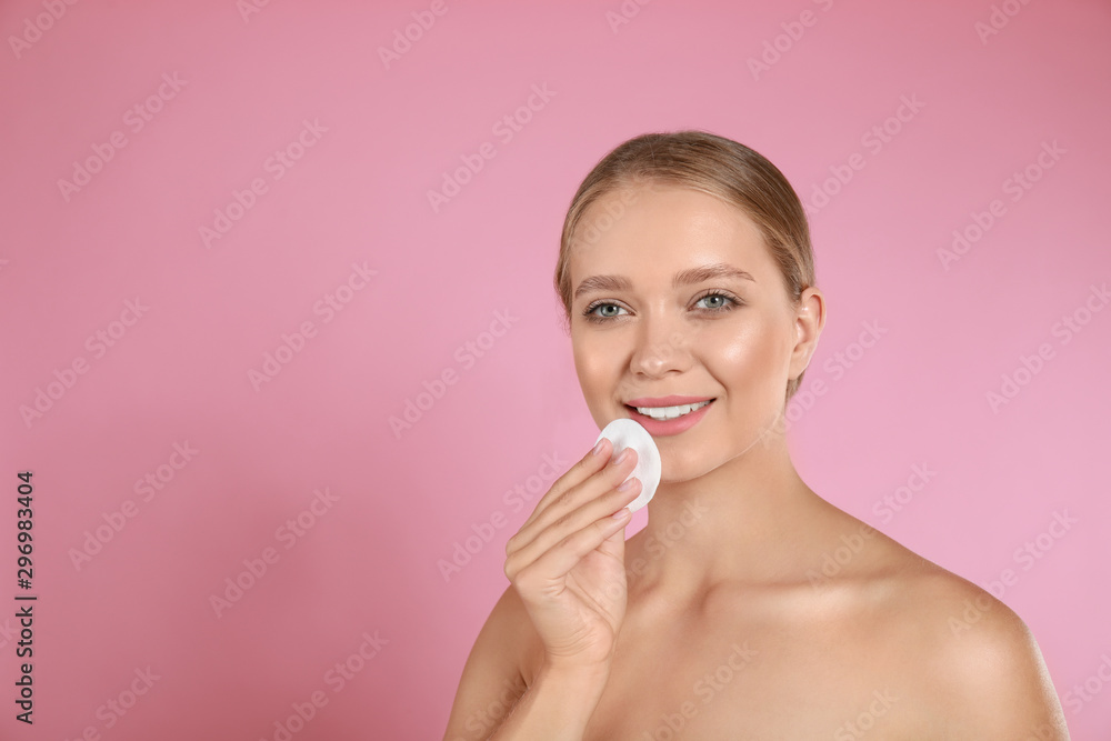 Beautiful young woman with cotton pad on pink background. Space for text Beautiful young woman with cotton pad on pink background. Space for text