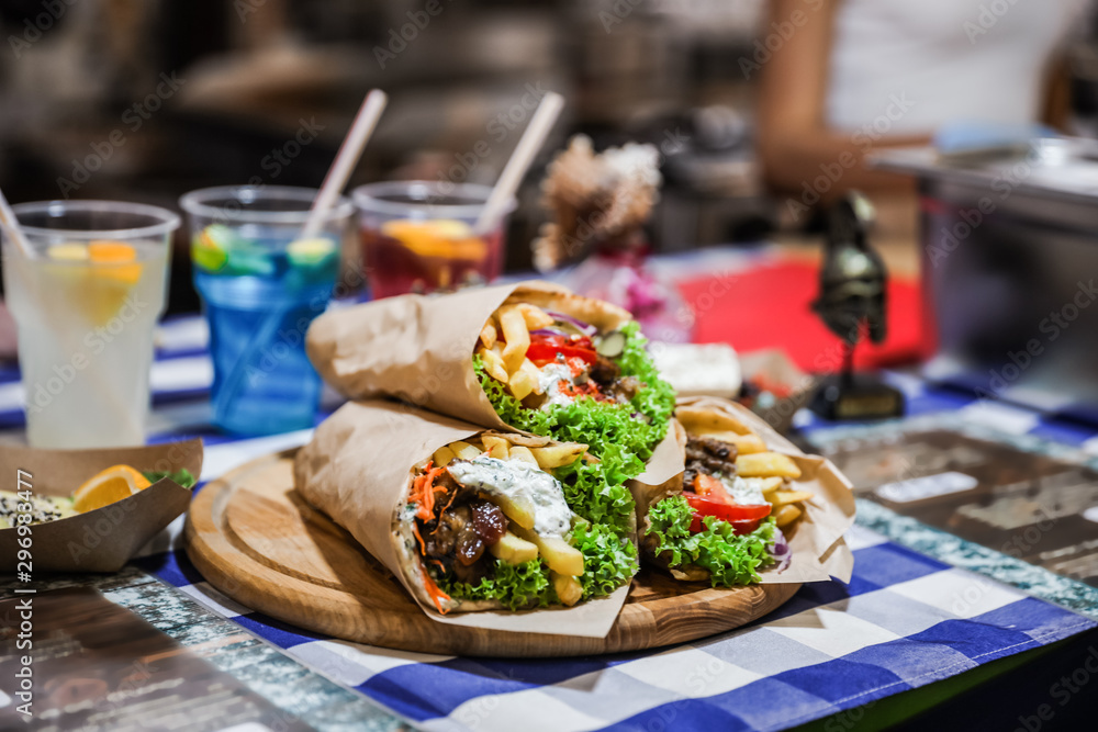 Tasty wraps with french fries on table. Fast food