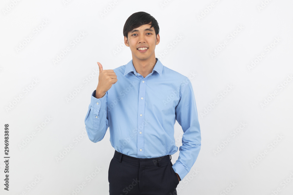 Young handsome asian business man smiling and showing thumbs up isolated on white background. Young handsome asian business man smiling and showing thumbs up isolated on white background.