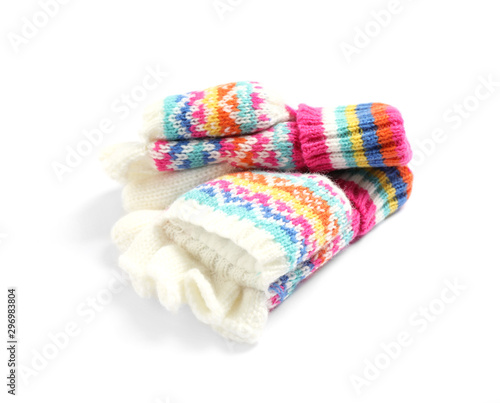 Warm knitted kid's mittens on white background