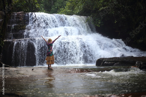A woman standing in Pang Sida waterfall of  Sa Kaeo ,Thailand