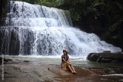 A woman sitting in Pang Sida waterfall of Sa Kaeo ,Thailand