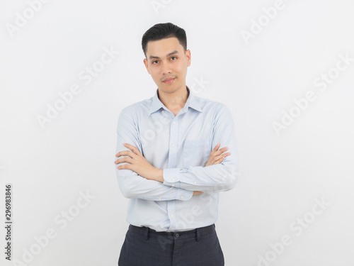 Young handsome asian business man looking to camera with arms crossed isolated on white background.