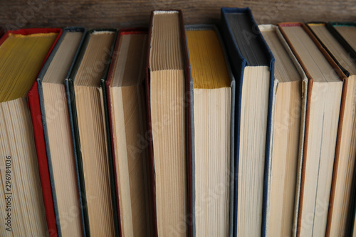 Stack of hardcover books on wooden background