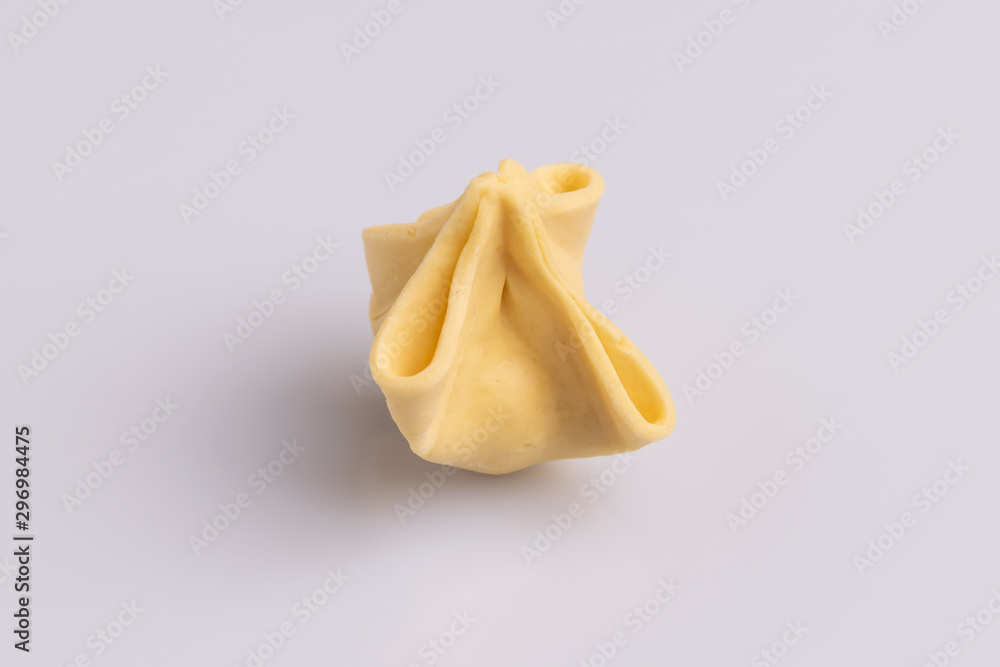 Fagottini Tortellini pasta isolated in white background, soft light, studio photo