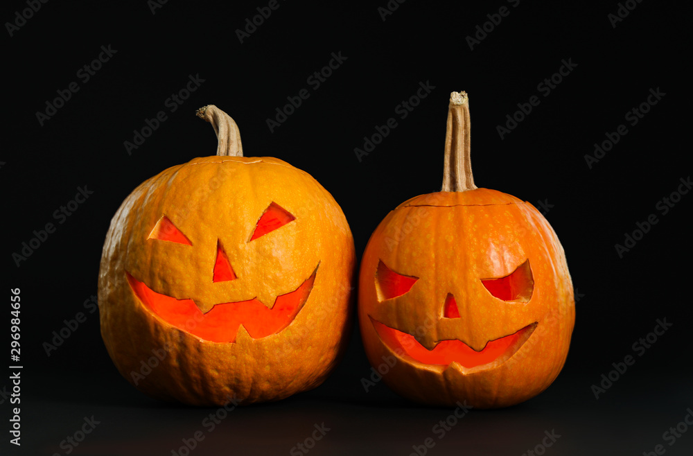 Pumpkin heads on black background. Jack lantern - traditional Halloween decor Pumpkin heads on black background. Jack lantern - traditional Halloween decor