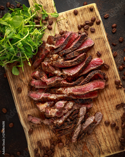 Bild auf Leinwand Freshly cooked seasoned with home made coffee rub sliced beef steak served on wo