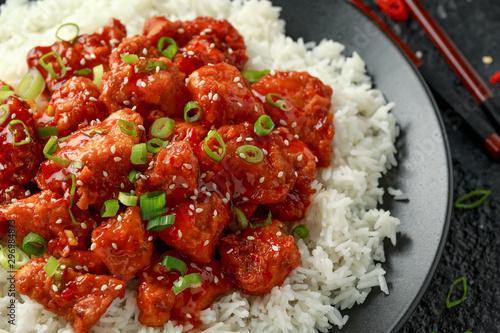 Tso's chicken with rice, green onion and broccoli photo