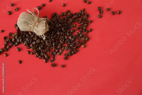 organic coffee beans in burlap on the red background. Coffee concept.