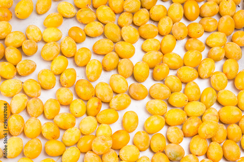 yellow fresh ripe plums placed on table in market. Vegetarian or healthy eating. yellow fresh ripe plums placed on table in market. Vegetarian or healthy eating.