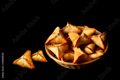 Fatayer - Stuffed baked spinach pies in basket black background