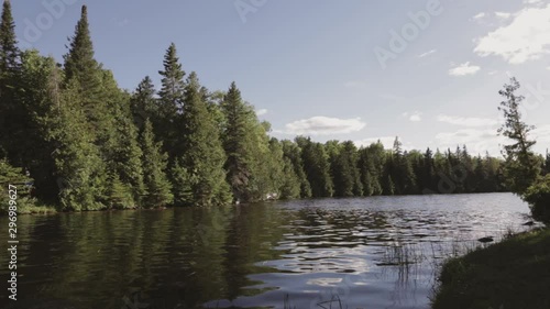 Beautiful view of lake during a sunny day. Trees and clouds in the background. photo